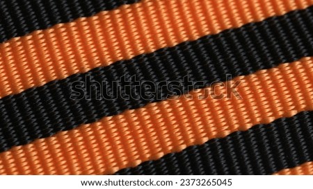 Background of orange and black St George ribbon