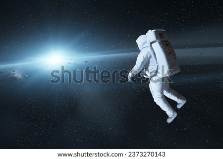 Cosmonaut in deep space with sun light. Elements of this image furnished by NASA.