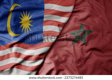 big waving realistic national colorful flag of malaysia and national flag of morocco . macro