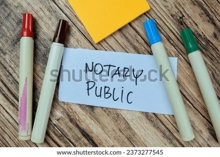 Concept of Notary Public write on sticky notes isolated on Wooden Table.