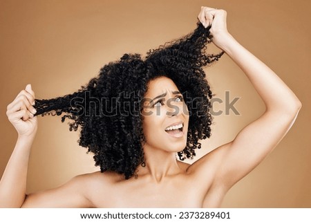 Afro woman, studio face and hair problem, anxiety or frustrated with grooming mistake, beauty salon treatment or breakage. Hairstyle disaster, bad frizz and model girl stress on brown background Royalty-Free Stock Photo #2373289401