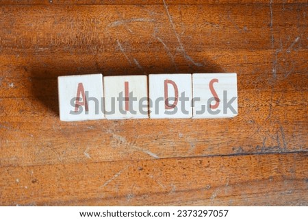 Wooden blocks make up the word "AIDS" in English. Wooden block object