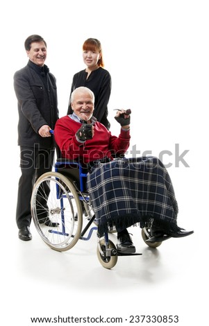 old man on wheelchair with younger man and woman