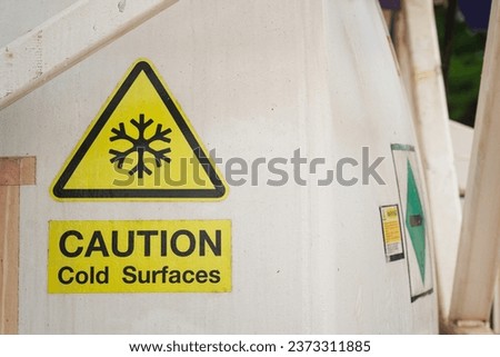 Safety sign of "Cold surface" caution which showed on liquid nitrogen storage tank. Industrial equipment with safety symbol.