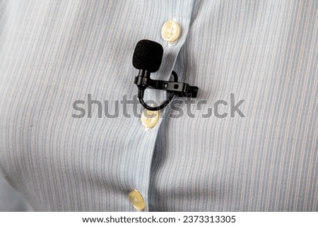 lavalier microphone for voice recording on the shirt. audio device technology. wired small microphone