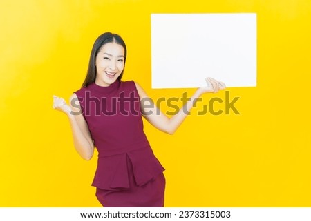 Portrait beautiful young asian woman with empty white billboard on color background