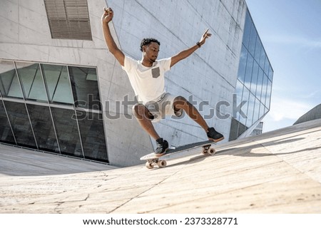 Surf skater training surfing moves on a urban scene. Royalty-Free Stock Photo #2373328771