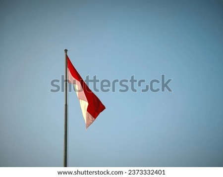 Flag of Indonesia - Red and White with blue sky background 