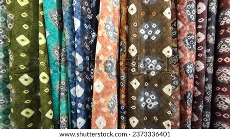 lot of batik fabric on the display at an event