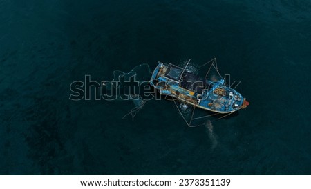 Close-up of the moment the boat drops its net and prepares to pull fish at sea Royalty-Free Stock Photo #2373351139