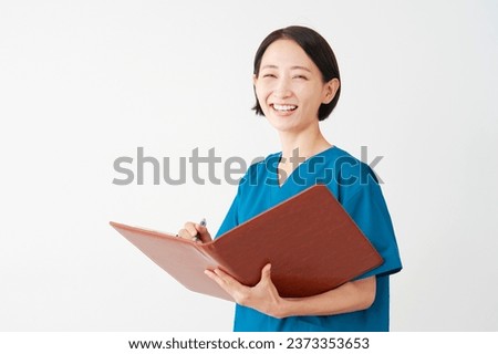 Asian middle aged doctor holding file and writing papers in white background