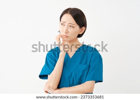 Asian middle aged doctor having trouble in white background Royalty-Free Stock Photo #2373353681