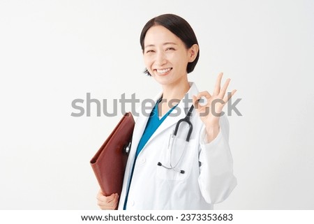 Asian middle aged doctor with the file OK gesture in white background