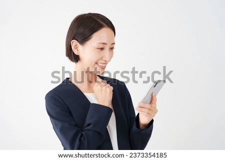 Asian middle aged businesswoman with the smartphone using in white background