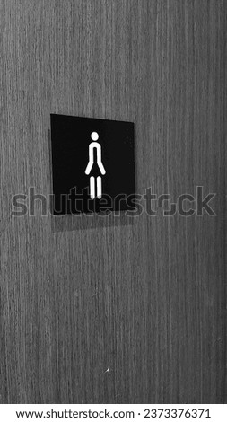 Woman toilet signage in monochrome on  the door 
