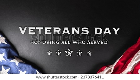 Happy Veterans day concept made from American flag and the text on dark wooden background. Royalty-Free Stock Photo #2373376411