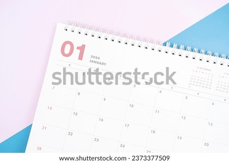 January 2024 calendar close up on blue and pink background, planning concept.