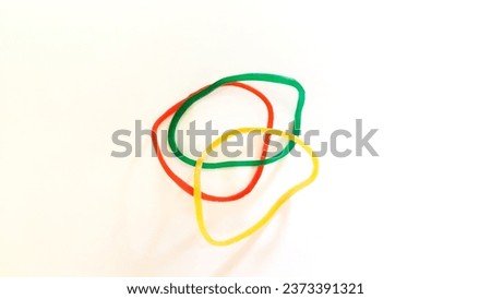picture of three rubber bracelets colored red, green and yellow.
