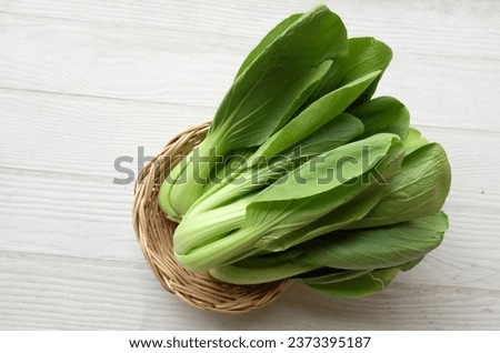 fresh and yummy green leaves Bok choy,Chinese cabbage,cantonese lettuce ,Bok Choy(Chinese cabbage) small choy sum,green pak choi, chinese chard (brassica rapa subsp. chinensis) in bamboo basket  Royalty-Free Stock Photo #2373395187