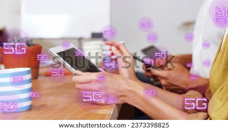 Image of multiple 5g texts over diverse coworkers using digital tablets in office. Digital composite, multiple exposure, business, telecommunication, abstract and technology concept.
