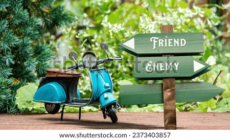 Street Sign the Direction Way to Friend versus Enemy Royalty-Free Stock Photo #2373403857