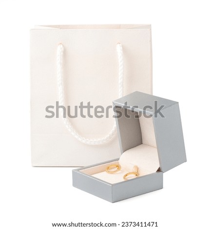 Golden earrings in jewelry box isolated on white background