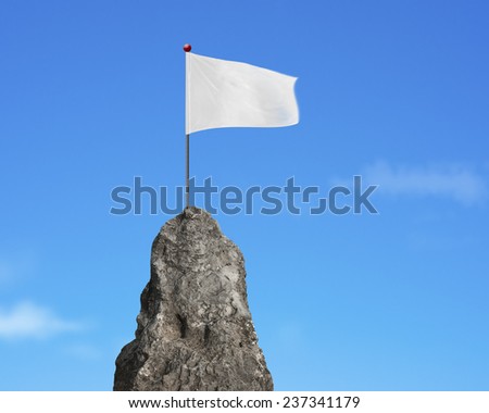 blank white flag on the mountain peak with natural sky cloud background 