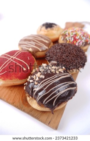 
Colorful chocolate topping donuts are delightful pastries adorned with a vibrant array of chocolate glazes, sprinkles, or decorative elements. With Background White.