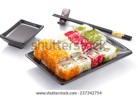 sushi rolls in a black ceramic plate isolated on white