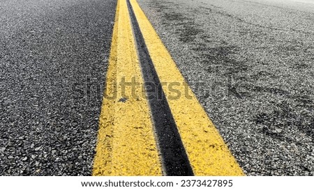 The dividing line of a roadway that divides the roadway on which vehicles travel in a city in the United States of America. Royalty-Free Stock Photo #2373427895