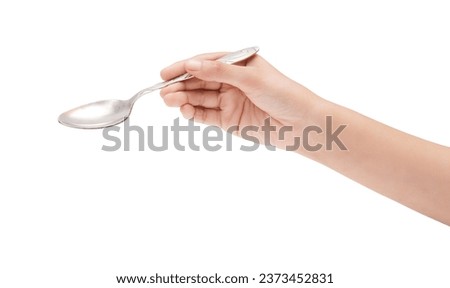 Female Hand Holding A Silver Stainless Spoon Closeup Photo Isolated On White Background Royalty-Free Stock Photo #2373452831