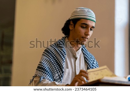 A Muslim prays in the holy mosque with the help of the Koran alone and asks Allah to help him