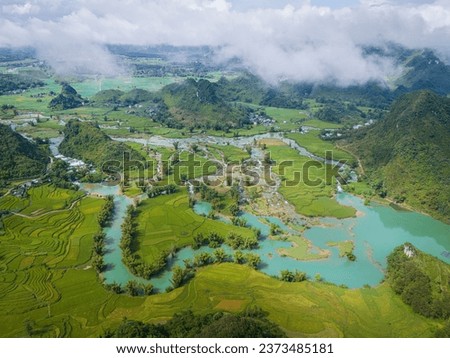 Aerial landscape in Quay Son river, Trung Khanh, Cao Bang, Vietnam with nature, green rice fields and rustic indigenous houses. Travel and landscape concept. Royalty-Free Stock Photo #2373485181