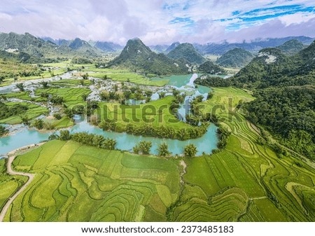 Aerial landscape in Quay Son river, Trung Khanh, Cao Bang, Vietnam with nature, green rice fields and rustic indigenous houses. Travel and landscape concept. Royalty-Free Stock Photo #2373485183