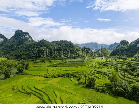 Aerial landscape in Quay Son river, Trung Khanh, Cao Bang, Vietnam with nature, green rice fields and rustic indigenous houses. Travel and landscape concept. Royalty-Free Stock Photo #2373485211