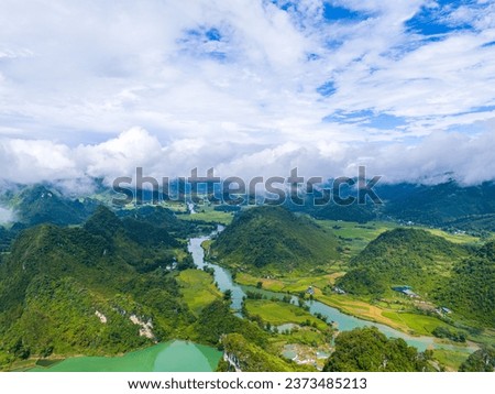 Aerial landscape in Quay Son river, Trung Khanh, Cao Bang, Vietnam with nature, green rice fields and rustic indigenous houses. Travel and landscape concept. Royalty-Free Stock Photo #2373485213