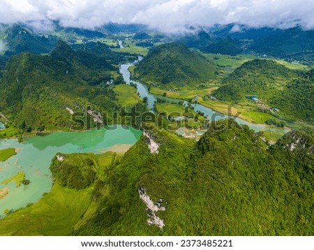Aerial landscape in Quay Son river, Trung Khanh, Cao Bang, Vietnam with nature, green rice fields and rustic indigenous houses. Travel and landscape concept. Royalty-Free Stock Photo #2373485221