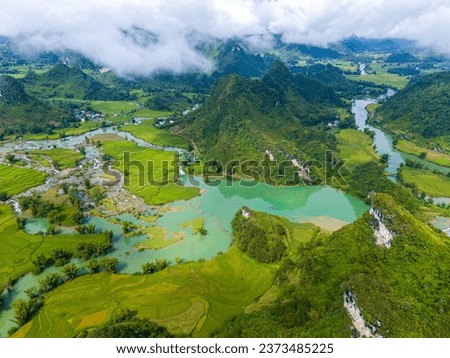 Aerial landscape in Quay Son river, Trung Khanh, Cao Bang, Vietnam with nature, green rice fields and rustic indigenous houses. Travel and landscape concept. Royalty-Free Stock Photo #2373485225