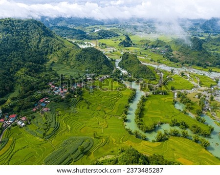 Aerial landscape in Quay Son river, Trung Khanh, Cao Bang, Vietnam with nature, green rice fields and rustic indigenous houses. Travel and landscape concept. Royalty-Free Stock Photo #2373485287