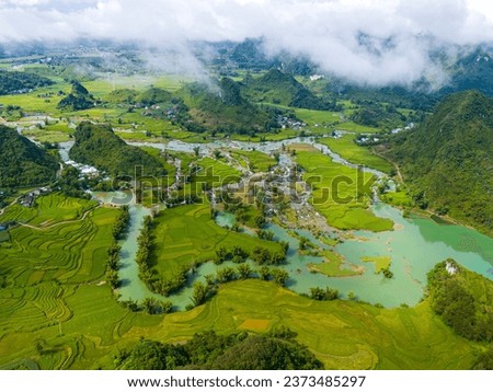 Aerial landscape in Quay Son river, Trung Khanh, Cao Bang, Vietnam with nature, green rice fields and rustic indigenous houses. Travel and landscape concept. Royalty-Free Stock Photo #2373485297