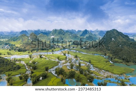 Aerial landscape in Quay Son river, Trung Khanh, Cao Bang, Vietnam with nature, green rice fields and rustic indigenous houses. Travel and landscape concept. Royalty-Free Stock Photo #2373485313