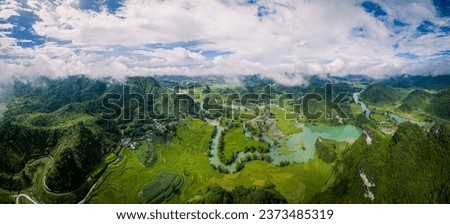 Aerial landscape in Quay Son river, Trung Khanh, Cao Bang, Vietnam with nature, green rice fields and rustic indigenous houses. Travel and landscape concept. Royalty-Free Stock Photo #2373485319