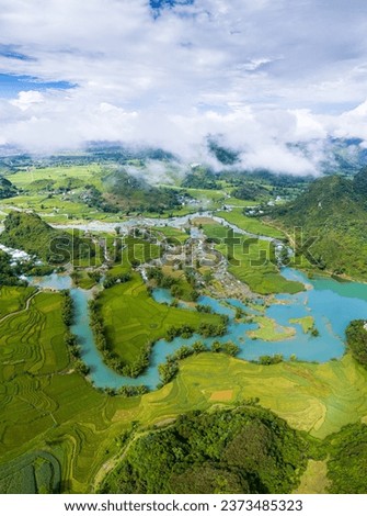 Aerial landscape in Quay Son river, Trung Khanh, Cao Bang, Vietnam with nature, green rice fields and rustic indigenous houses. Travel and landscape concept. Royalty-Free Stock Photo #2373485323