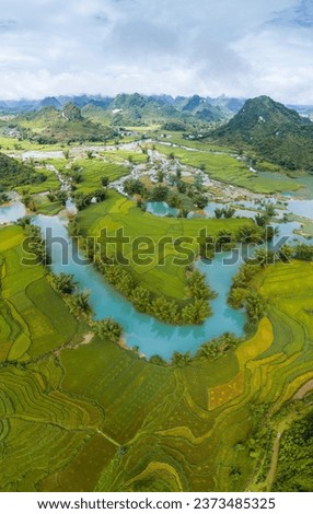 Aerial landscape in Quay Son river, Trung Khanh, Cao Bang, Vietnam with nature, green rice fields and rustic indigenous houses. Travel and landscape concept. Royalty-Free Stock Photo #2373485325