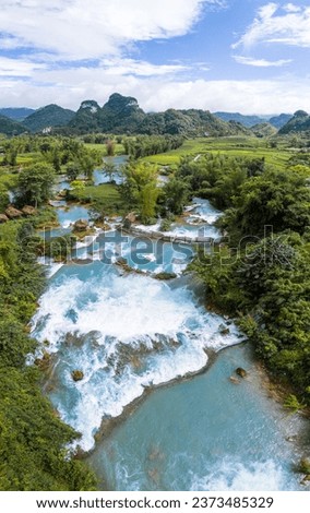 Aerial landscape in Quay Son river, Trung Khanh, Cao Bang, Vietnam with nature, green rice fields and rustic indigenous houses. Travel and landscape concept. Royalty-Free Stock Photo #2373485329