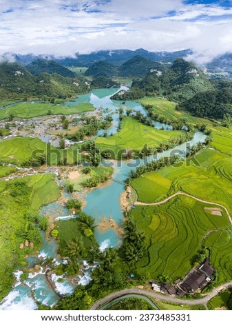 Aerial landscape in Quay Son river, Trung Khanh, Cao Bang, Vietnam with nature, green rice fields and rustic indigenous houses. Travel and landscape concept. Royalty-Free Stock Photo #2373485331