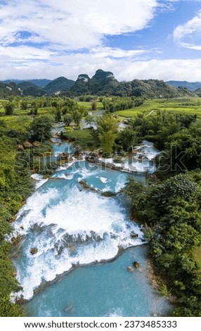Aerial landscape in Quay Son river, Trung Khanh, Cao Bang, Vietnam with nature, green rice fields and rustic indigenous houses. Travel and landscape concept. Royalty-Free Stock Photo #2373485333