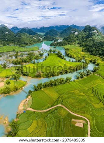 Aerial landscape in Quay Son river, Trung Khanh, Cao Bang, Vietnam with nature, green rice fields and rustic indigenous houses. Travel and landscape concept. Royalty-Free Stock Photo #2373485335