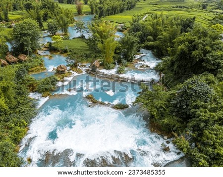 Aerial landscape in Quay Son river, Trung Khanh, Cao Bang, Vietnam with nature, green rice fields and rustic indigenous houses. Travel and landscape concept. Royalty-Free Stock Photo #2373485355