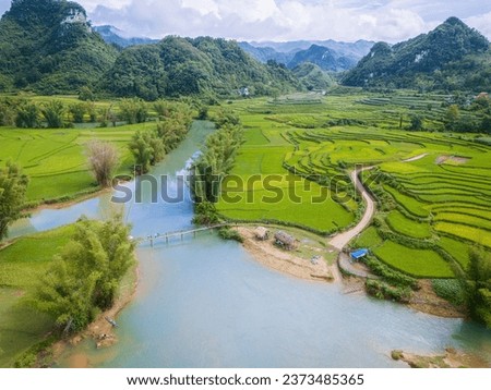 Aerial landscape in Quay Son river, Trung Khanh, Cao Bang, Vietnam with nature, green rice fields and rustic indigenous houses. Travel and landscape concept. Royalty-Free Stock Photo #2373485365